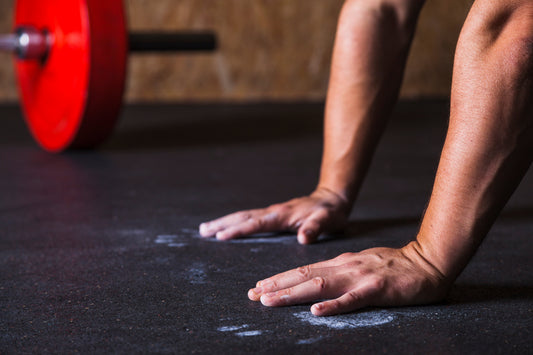 Lifter preparing a loaded barbell for a hypertrophy training session