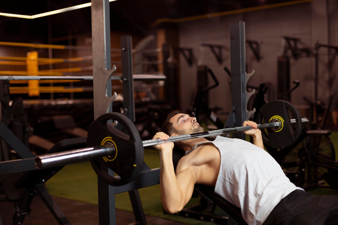 Focused lifter performing a barbell repetition with controlled technique